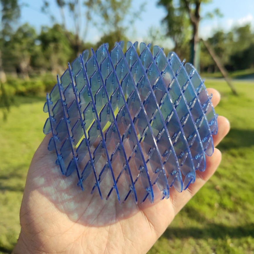 Blue Warp Worm sensory toy held in palm to show portable size and ergonomic shape