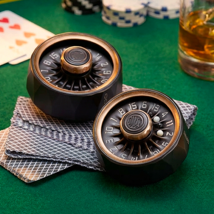 Two Starloop Turbine haptic gears on a green poker table - The ultimate decision maker and luxury EDC gift