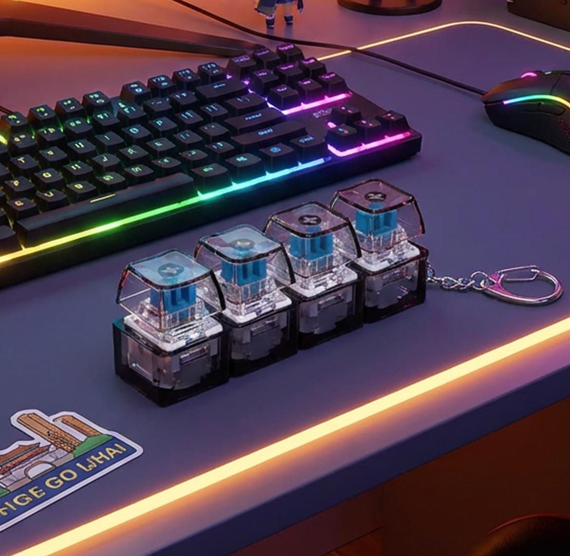 The Clickie 04 Glitch Series in Smoke Black - 4-key mechanical haptic fidget tool on an RGB gaming desk setup